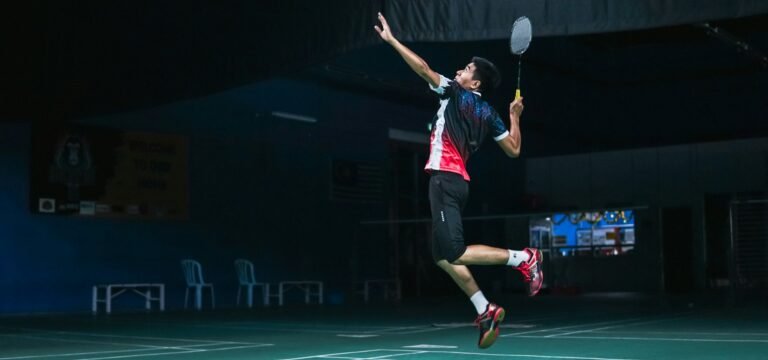 Badminton player jumping for a smash